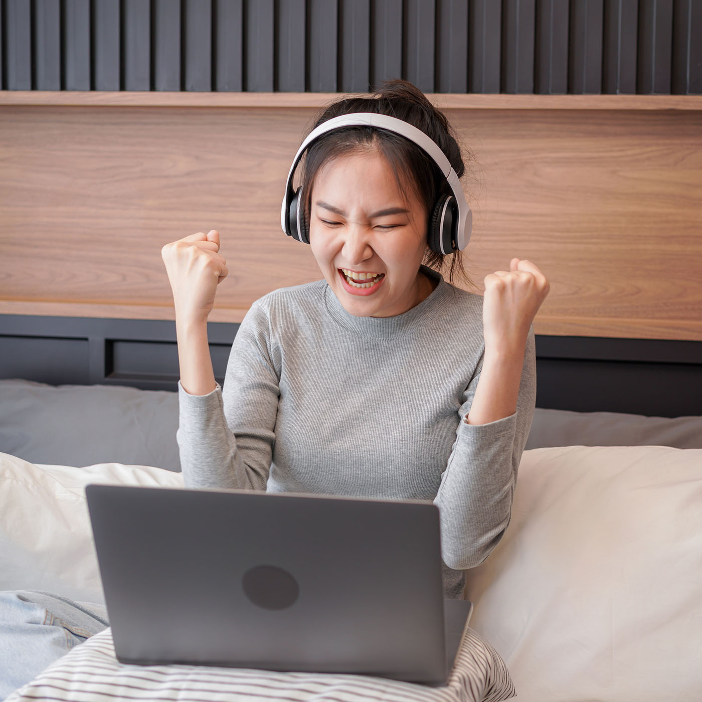 asian-woman-with-headphone-raising-hands-after-rec-2022-11-15-15-36-13-utc.jpg